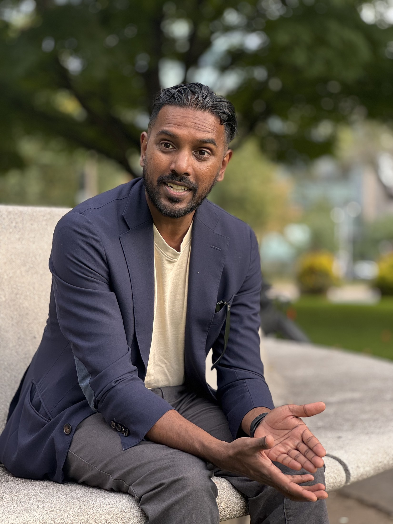 Christopher Balkaran listening attentively while seated outdoors